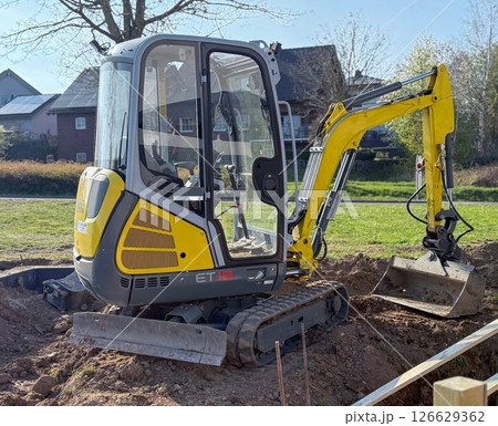 Excavator on earthmoving. Open-pit mining. Backhoe dig sand, ground in quarry. Heavy construction equipment on excavation on construction site. Excavator on groundwork, foundation. Road construction. 126629362