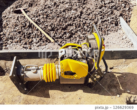 Small plate compactor, vibratory hammer, jumping jack machine, power tool at construction site Small plate compactor, vibratory hammer, jumping jack machine, power tool at construction site 126629369