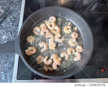 fried roasted shrimps in plate with lemon greens parsley garlic 126629376