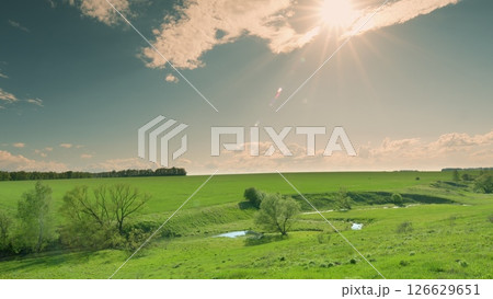 A Serene Green Landscape with a Beautiful Sunlit Sky and Absolutely Breathtaking Scenery Time lapse. A Serene Green Landscape with a Beautiful Sunlit Sky and Absolutely Breathtaking Scenery Time lapse. 126629651