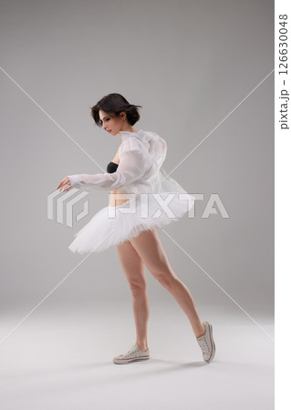 Elegant ballet dancer showcases beauty in lingerie and tulle in the studio Elegant ballet dancer showcases beauty in lingerie and tulle in the studio 126630048