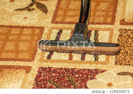 The head of a modern vacuum cleaner against the background of a carpet. Close. 126630071