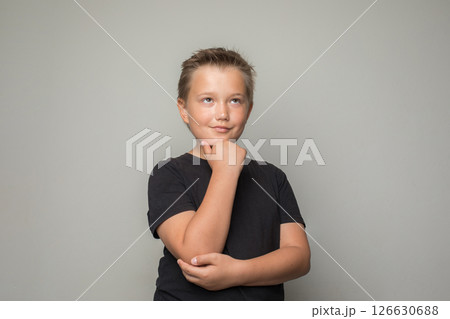 Portrait of young boy child looking up and thinking on white background Portrait of young boy child looking up and thinking on white background 126630688