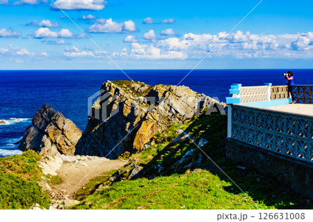 Tourist with camera on Asturias coast, Spain Tourist with camera on Asturias coast, Spain 126631008