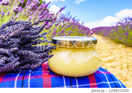 Jar with honey and lavender flowers. Jar with honey and lavender flowers. 126631050