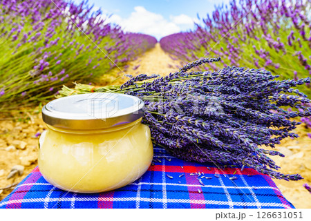 Jar with honey and lavender flowers. Jar with honey and lavender flowers. 126631051