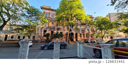 Facade of a historic building with balconies. View of a beautiful building in old Odessa with a pink facade. Facade of a historic building with balconies. View of a beautiful building in old Odessa with a pink facade. 126631441