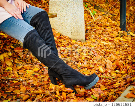 Woman wearing black knee high boots 126631681