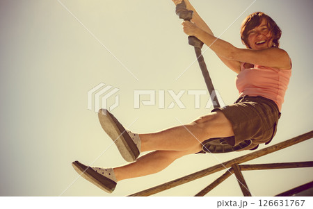 Adult woman having fun on zipline Adult woman having fun on zipline 126631767