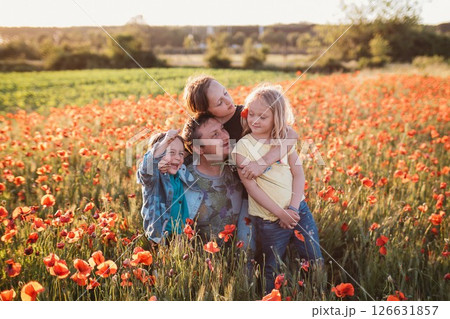 Joyful Family Moment in a Poppy Field Joyful Family Moment in a Poppy Field 126631857