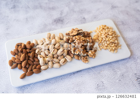 A Beautiful Variety of Nuts Arranged on a Serving Board for Healthy and Delicious Snacking Options 126632481