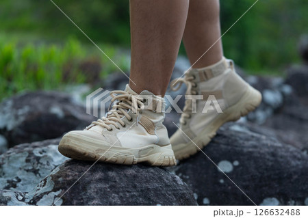 Close-up of the legs of a female hiker walking on a mountain trail. Close-up of the legs of a female hiker walking on a mountain trail. 126632488