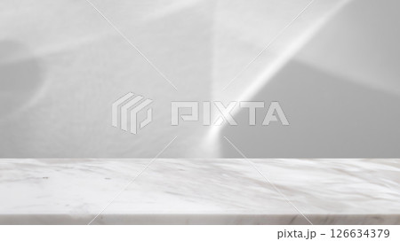 Marble table top with abstract shadow drop on white wall background for mockup product display 126634379