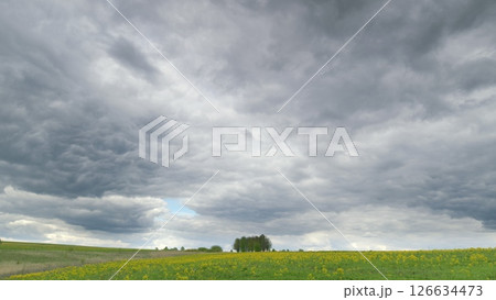 A Serene and Beautiful Landscape Under Dramatic, Dynamic Cloudy Skies Awaits You Time lapse. A Serene and Beautiful Landscape Under Dramatic, Dynamic Cloudy Skies Awaits You Time lapse. 126634473