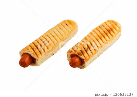 Grilled hot dogs served in toasted buns at a picnic gathering Grilled hot dogs served in toasted buns at a picnic gathering 126635137