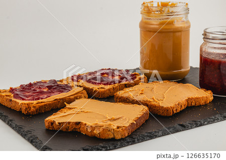 Peanut butter and jelly sandwiches prepared on a slate board Peanut butter and jelly sandwiches prepared on a slate board 126635170