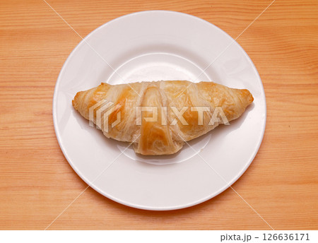 Baked crispy croissant on plate Baked crispy croissant on plate 126636171