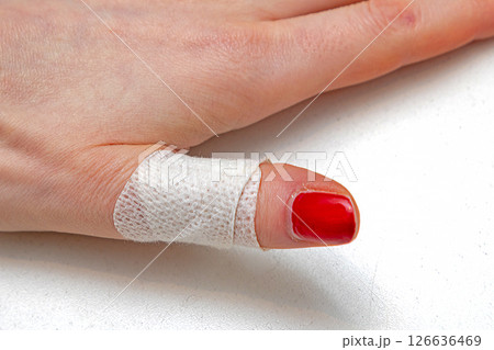 Plaster band aid on human finger 126636469