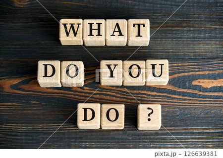 WHAT DO YOU DO phrase on wooden blocks 126639381