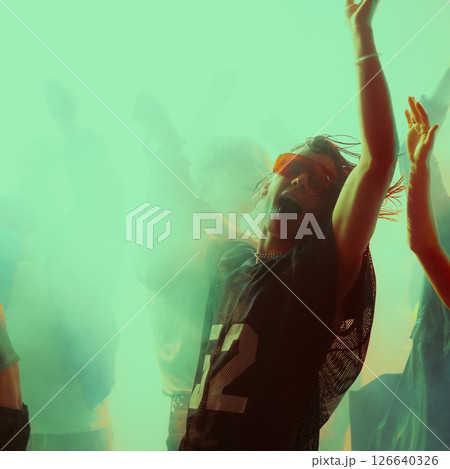 Dynamic group dance party. Vibrant lighting with people celebrating. 126640326