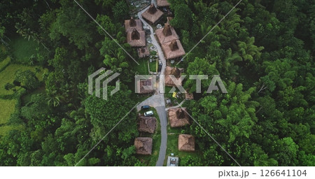 Aerial view of a traditional village nestled within a dense tropical forest in Sumba island, Indonesia, showcasing the harmonious blend of nature and culture 126641104