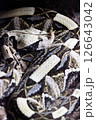 A rattlesnake is laying on the sand, with its head facing the camera. 126643042