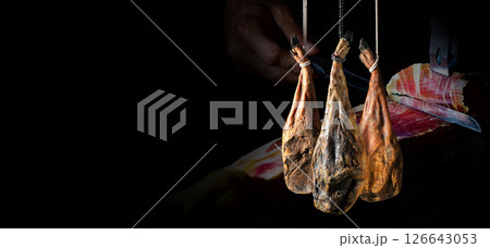 Dry Spanish ham, Jamon Serrano, Bellota, Italian Prosciutto Crudo or Parma ham. Dry Spanish ham, Jamon Serrano, Bellota, Italian Prosciutto Crudo or Parma ham. 126643053