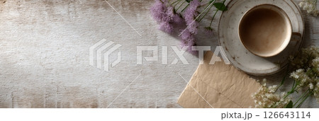 Scattered flowers and an elegant tea cup create a cozy and inviting atmosphere for storytelling 126643114