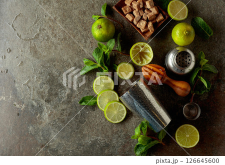 Wooden citrus squeezer, shaker, and ingredients for making summer refreshing drinks. Wooden citrus squeezer, shaker, and ingredients for making summer refreshing drinks. 126645600