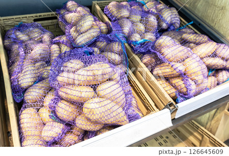 Fresh potatoes packed in bags selling at the grocery store 126645609