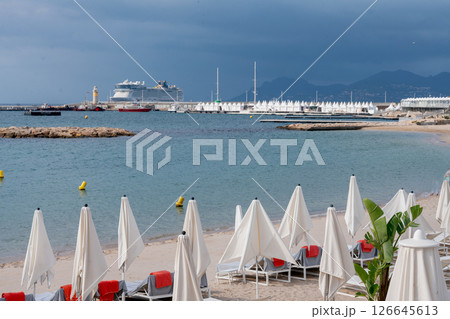 Beach with white sand and beach chairs and red towels 126645613