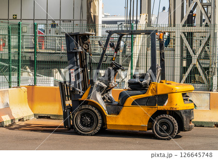 Yellow Industrial Forklift Truck Parked at Loading Area Yellow Industrial Forklift Truck Parked at Loading Area 126645748