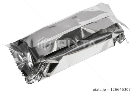 Close up of empty silver foil packaging for candy bar or snack, crumpled and sealed, isolated background. 126646302