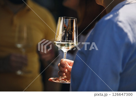 Close up of couple people drinking white sparkling wine outdoor. Alcoholic beverages tasting concept. Drinking on nature. 126647300