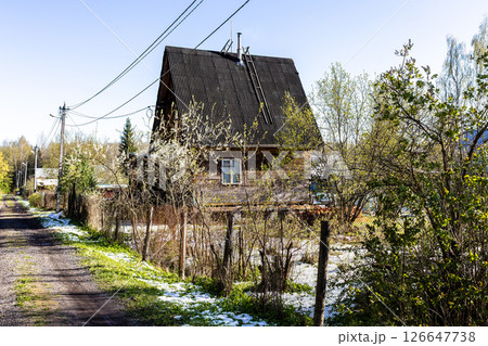 street in village after snow on sunny spring day street in village after snow on sunny spring day 126647738