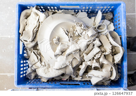 fragments of unfired porcelain in plastic box 126647937