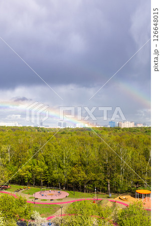 gray rainy clouds and two rainbow over playground gray rainy clouds and two rainbow over playground 126648015