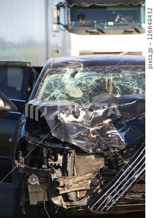 Broken engine compartment and mangled car engine after a head-on collision at high speed Broken engine compartment and mangled car engine after a head-on collision at high speed 126648432
