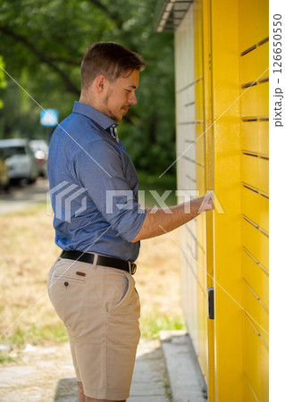 A man thoughtfully interacting with a vibrant and vivid yellow wall, creating a striking scene 126650550
