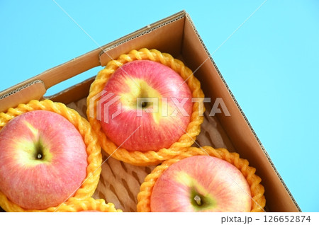 beautiful pink apple in the box on blue background 126652874