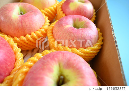 beautiful pink apple in the box on blue background 126652875