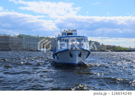 Enjoy a scenic riverboat ride on a sunny day in the vibrant city with stunning architecture Enjoy a scenic riverboat ride on a sunny day in the vibrant city with stunning architecture 126654240