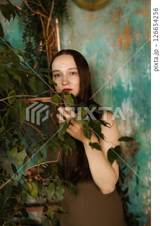 An Elegant Woman Surrounded by Lush Greenery with a Beautiful and Artistic Background 126654256