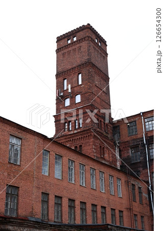 This is a historic red brick industrial building that features a tall tower on its design This is a historic red brick industrial building that features a tall tower on its design 126654300
