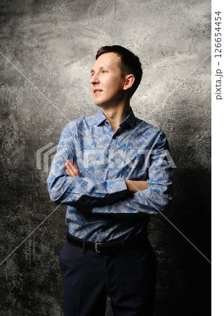 A Youthful Portrait Depicting a Person in Stylish and Trendy Attire Against a Blue Backdrop A Youthful Portrait Depicting a Person in Stylish and Trendy Attire Against a Blue Backdrop 126654454
