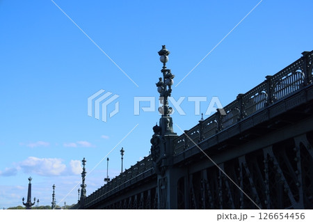 A Historic Bridge Set Against a Bright and Clear Blue Sky, Showcasing Remarkable Design Elements A Historic Bridge Set Against a Bright and Clear Blue Sky, Showcasing Remarkable Design Elements 126654456