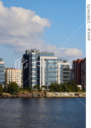 Stunning and Modern Waterfront Buildings Stand Majestically Against the Bright Blue Sky Stunning and Modern Waterfront Buildings Stand Majestically Against the Bright Blue Sky 126654478