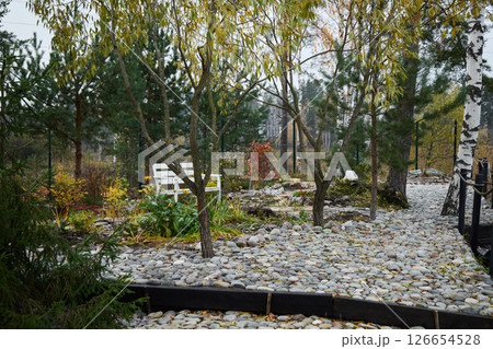 A Tranquil Autumn Garden featuring beautifully designed Pathways and comfortable Seating 126654528