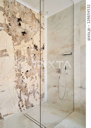 An Elegant and Modern Shower Featuring a Unique and Textured Wall Design for Luxurious Spaces An Elegant and Modern Shower Featuring a Unique and Textured Wall Design for Luxurious Spaces 126654532