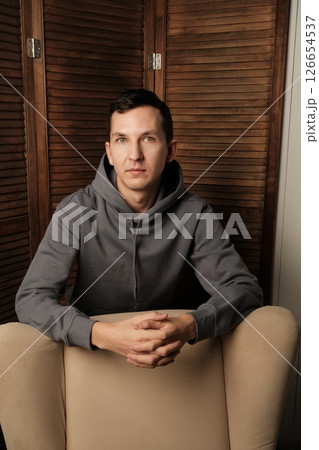 A Contemplative Portrait Set in a Modern Environment with Various Artistic Elements 126654537